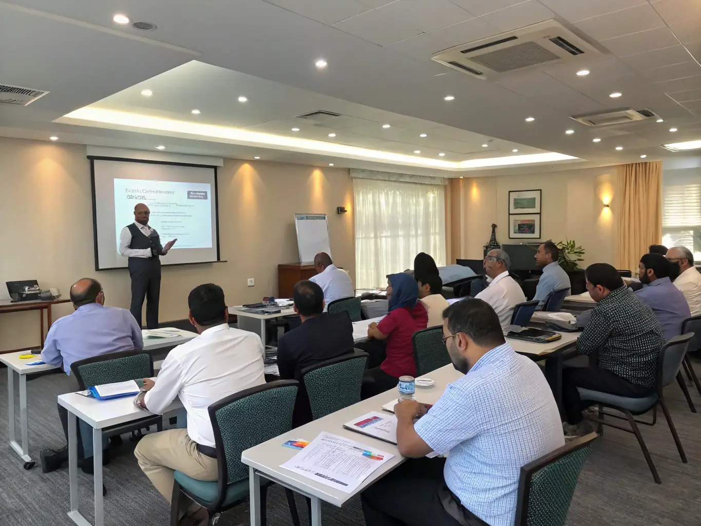 A photograph showcasing MELVOMS GLOBAL LIMITED employees participating in a company-sponsored training session on the latest automotive technologies. The image should highlight the company's commitment to employee development and continuous learning.